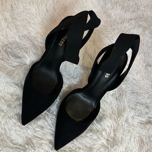 Black high heels with crisscross strap around ankle